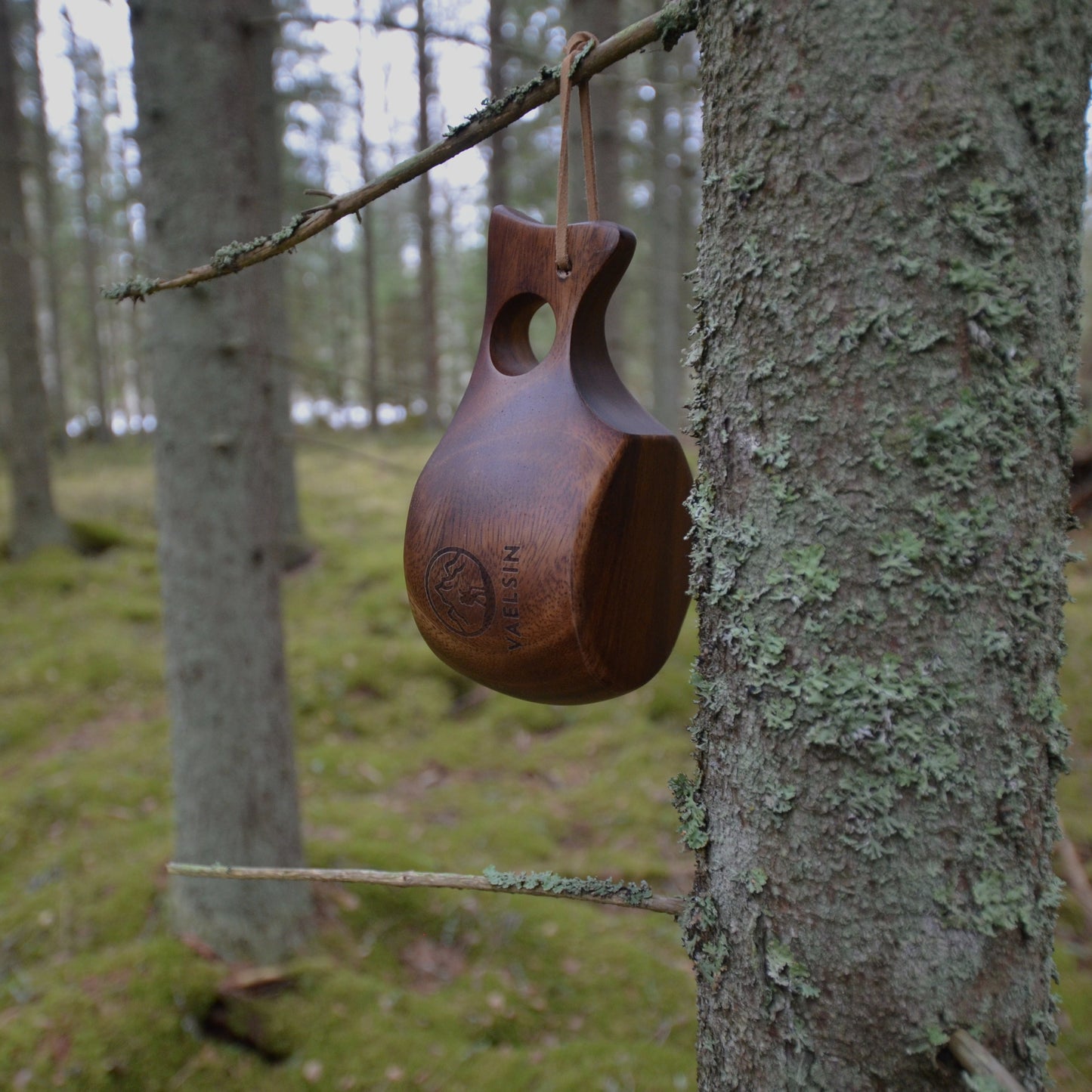Kuksa wooden mug hanging from a tree