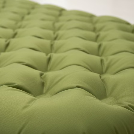 Close-up of a green tufted cushion